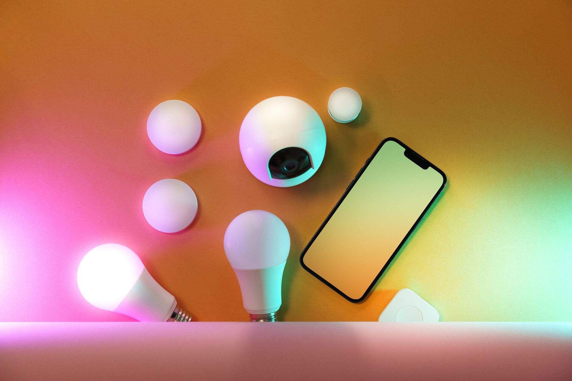Raw Silicone Pipes 1 A collection of smart home devices including light bulbs and a smartphone, showcasing modern technology.