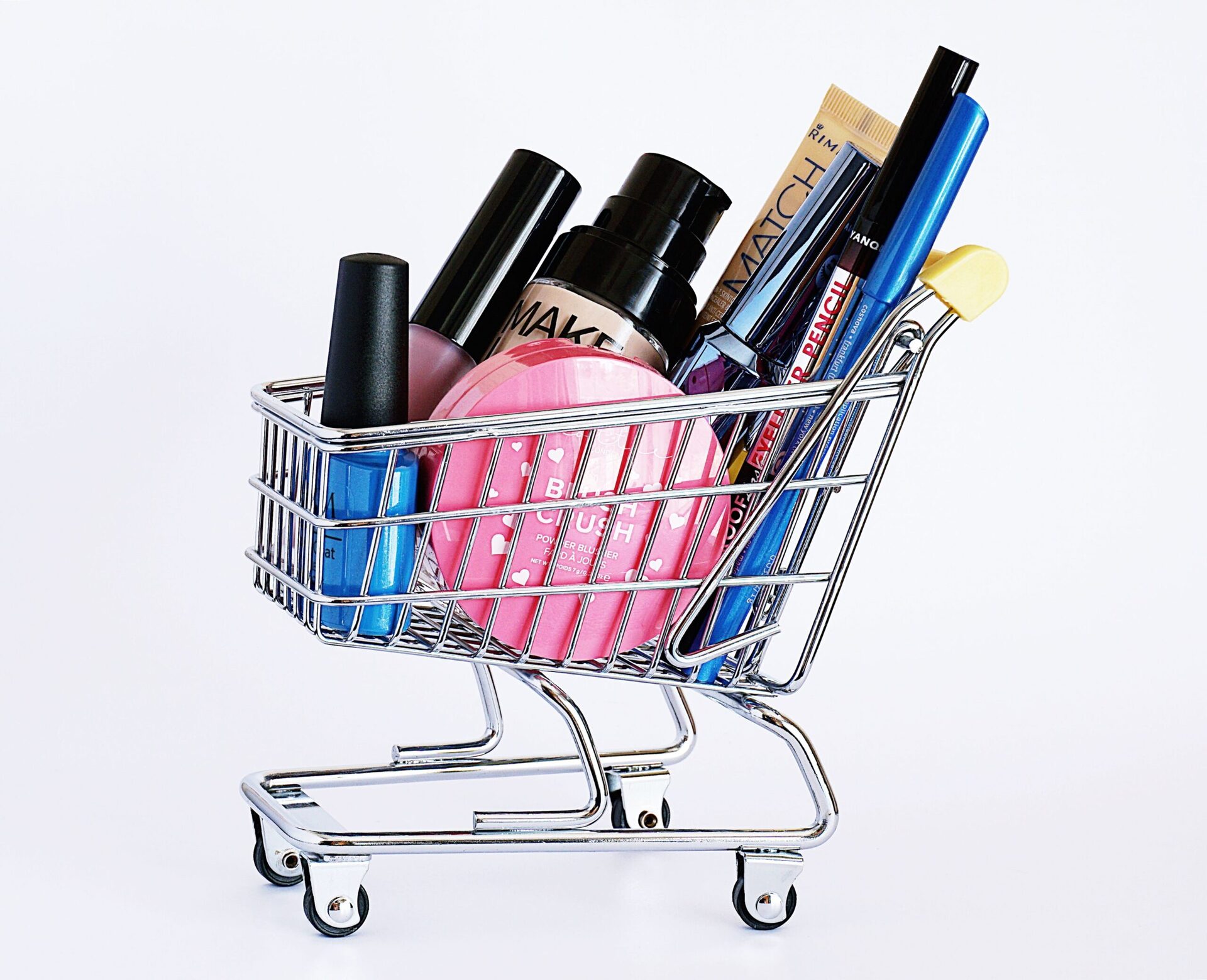 Synthetic Cotton Pipes 1 Miniature shopping cart filled with a variety of cosmetics on a white background.