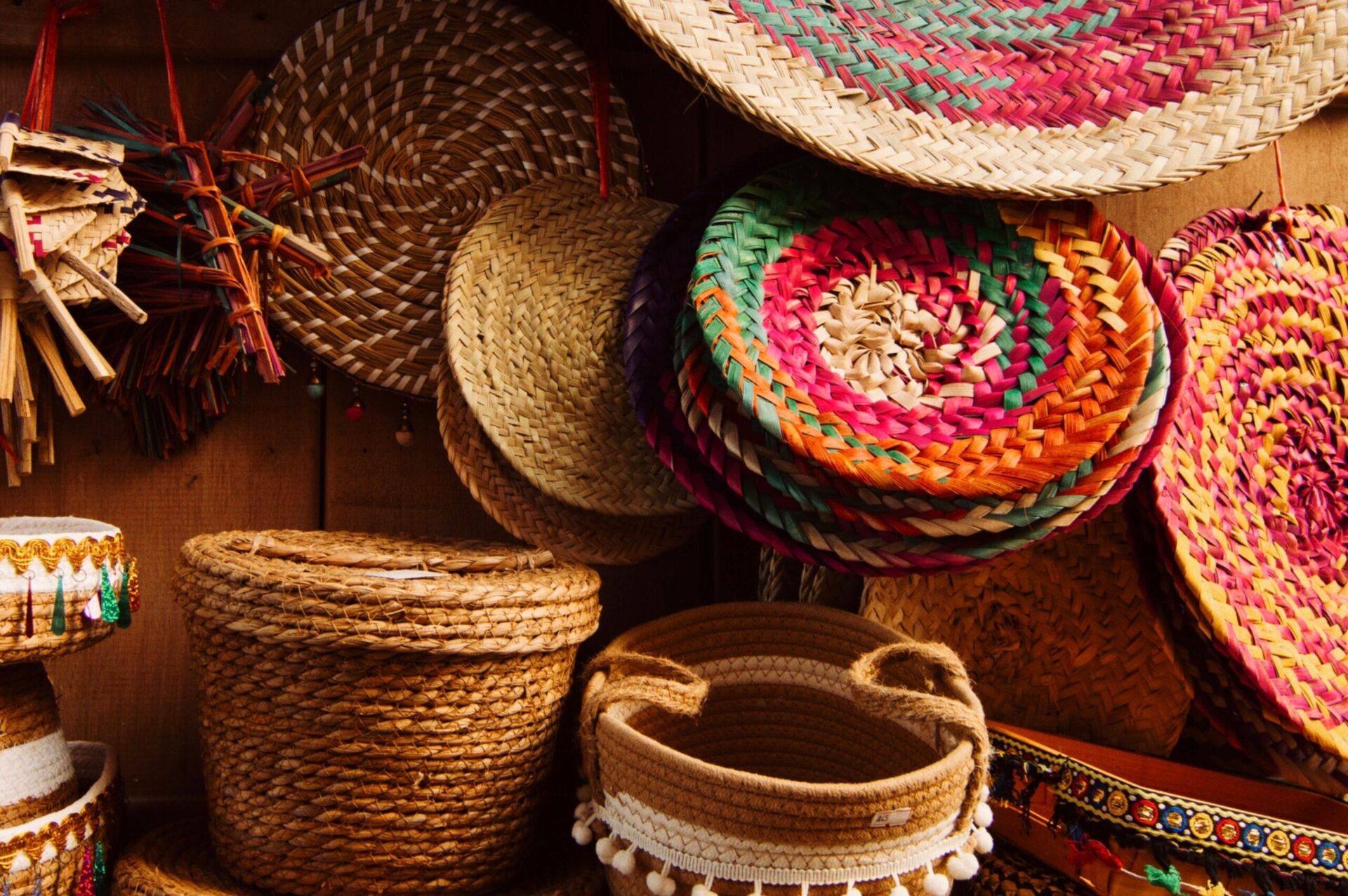 Magnesium & Omega-3 Supplement Capsules (60 Softgels) 1 Colorful handmade woven baskets and hats displayed on a wooden wall, showcasing traditional craftsmanship.