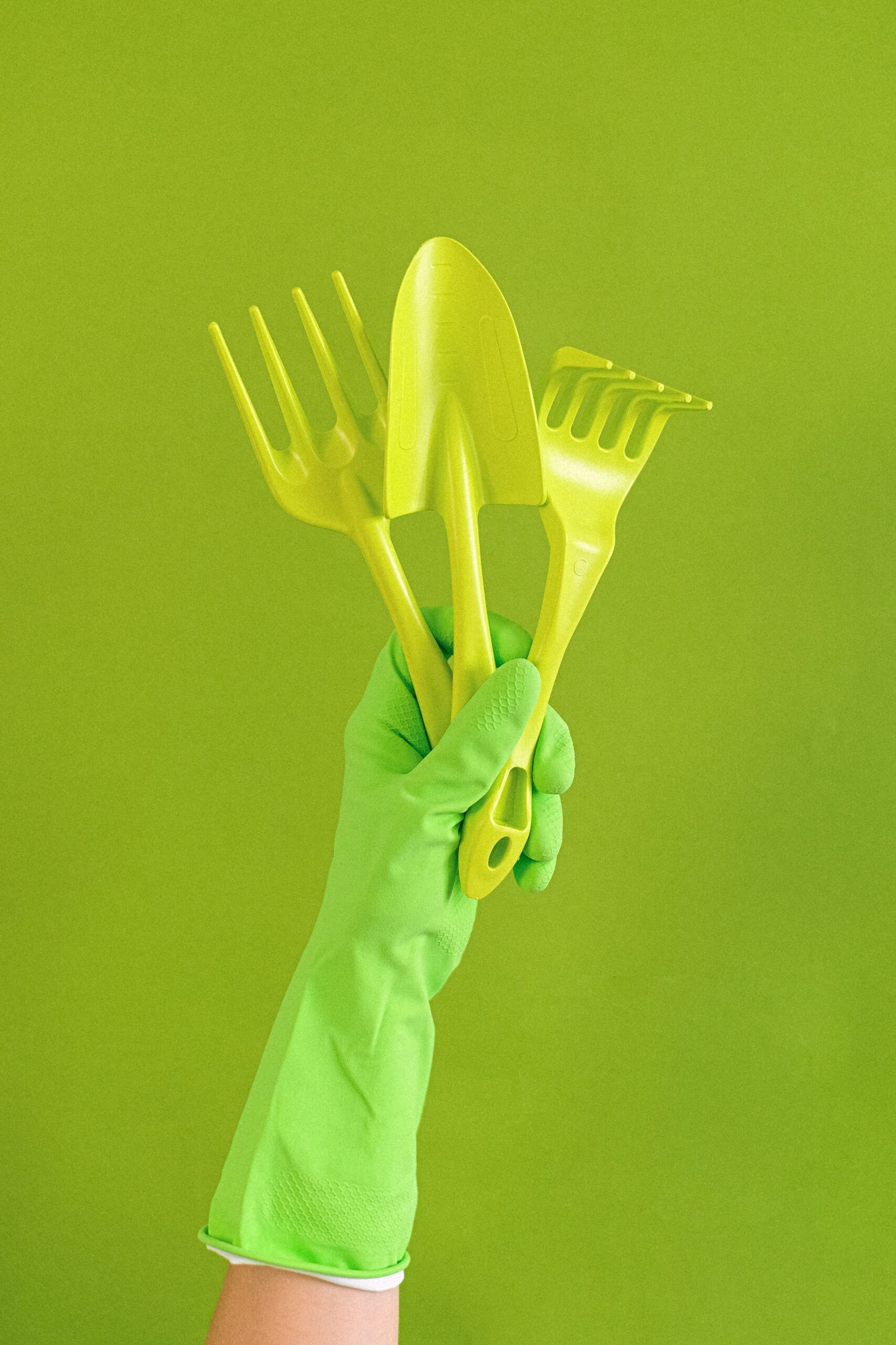 Premium Casual & Sports Shoes — Knitted Upper, Memory Foam 1 Crop anonymous person wearing rubber glove showing set of gardening tools including trowel and hand rake against green background
